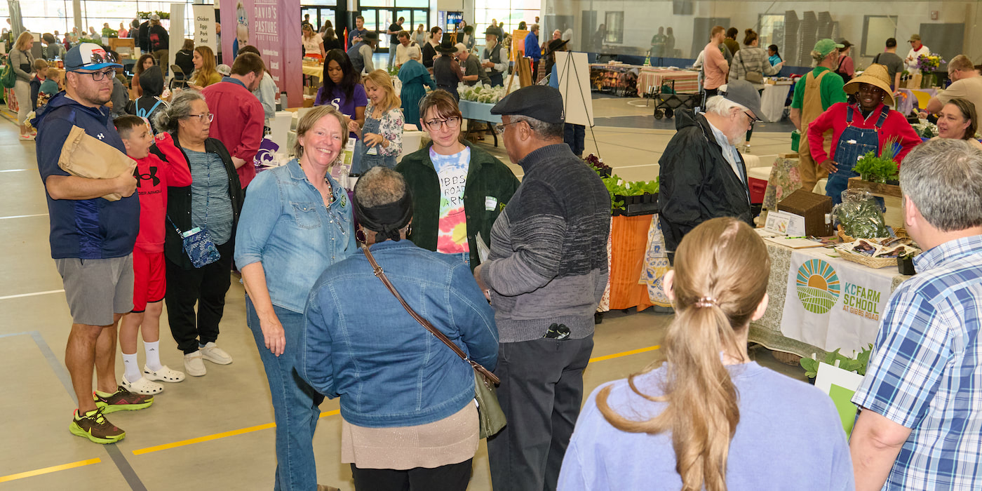 People at the expo talk with each other and shop vendor booths.